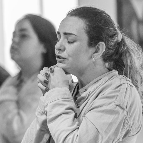 Serene woman with closed eyes focusing inward.